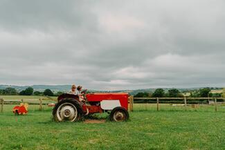 Kids playing on tractor at Rowlestone Court Farm