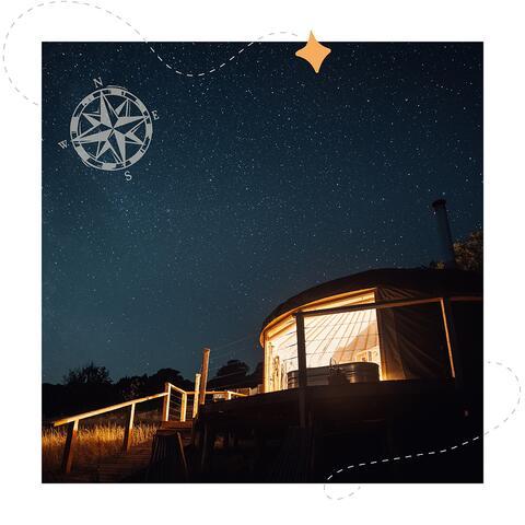 Photo of yurt under starry sky with superimposed graphics
