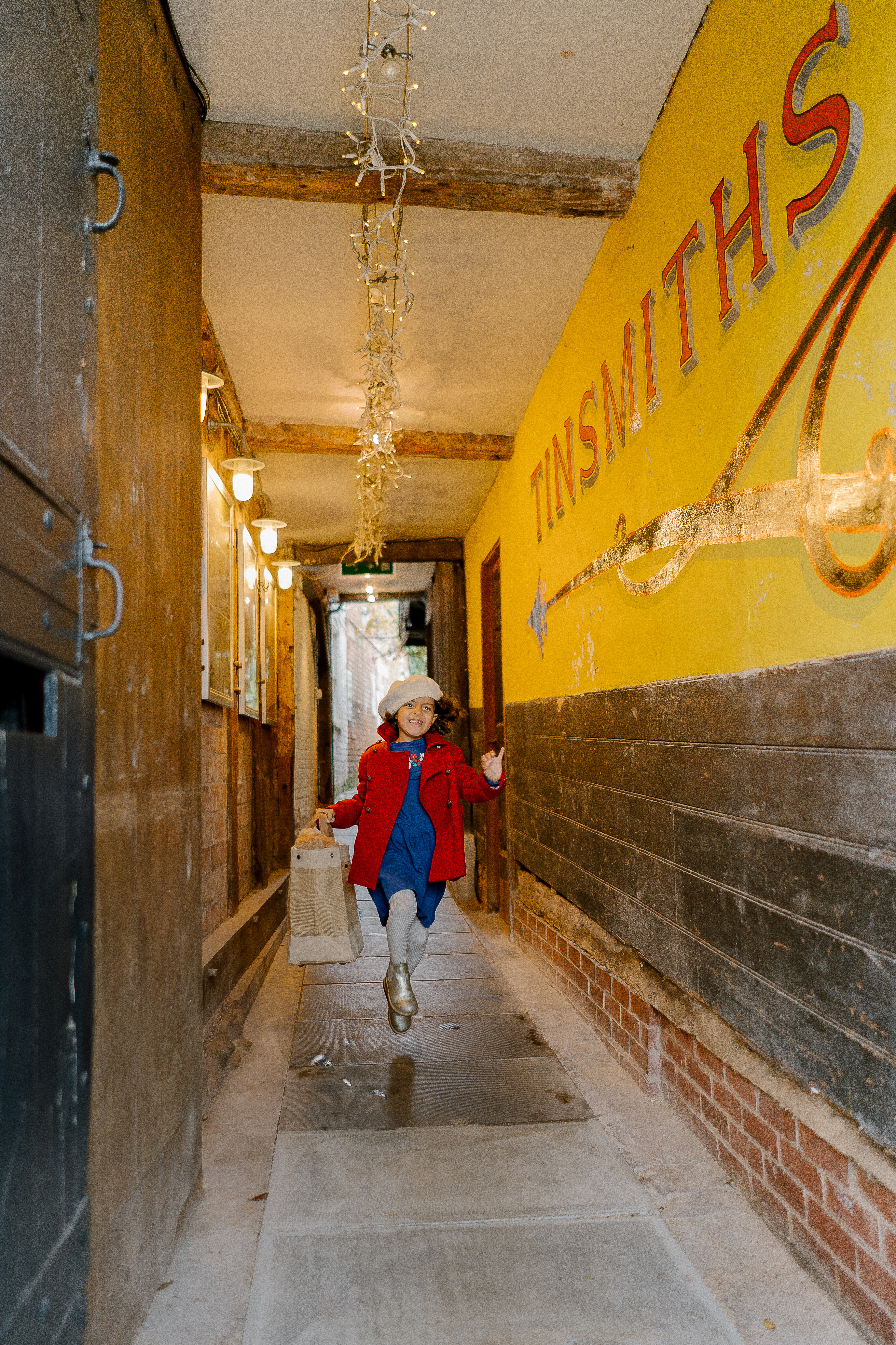 Little girl skipping along Tinsmiths Alley