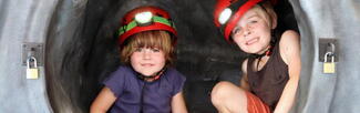 two children trying the mobile caving experience