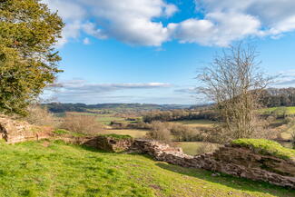 Scenic shot of rolling hills with Snodhill castle ruins in foreground