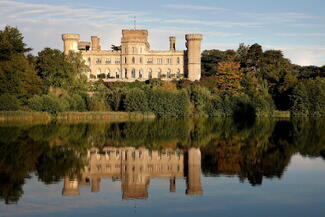 Eastnor castle overlooking a lake