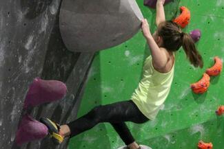 girl climbing bouldering wall
