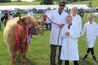 Family with prize winning bull