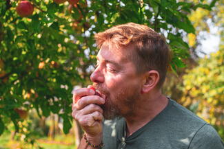 man biting into apple