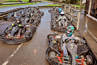 Go karts lined up on the track 