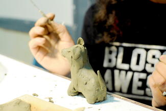 child enjoying pottery class