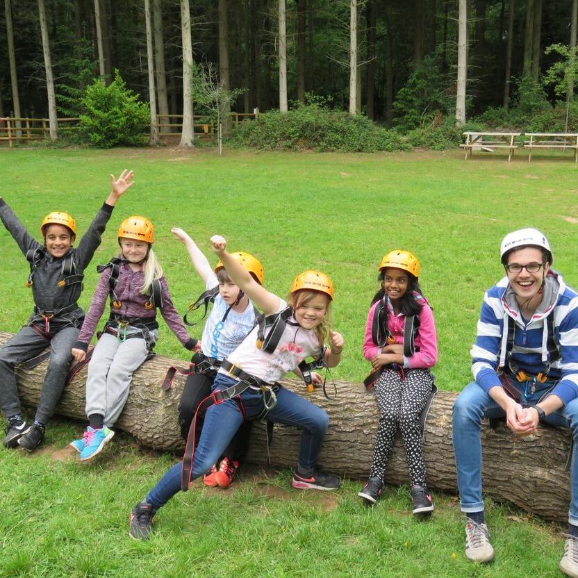 Group of young people on a log at Oaker Wood