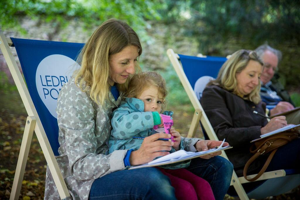 Lady on a festival deckchair with a baby