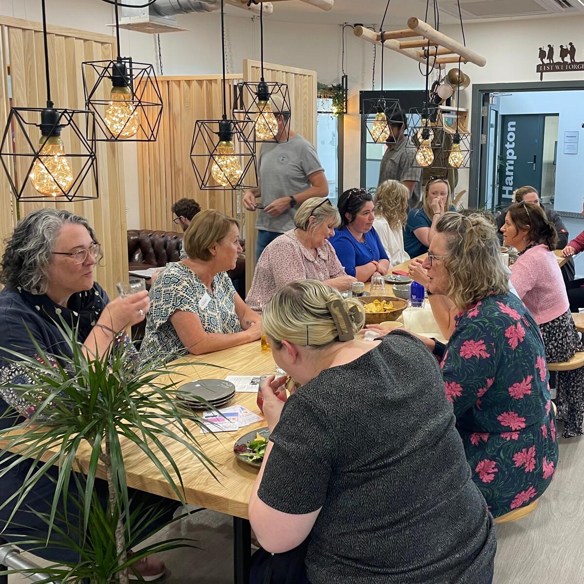 ladies sat around large dining table in a cafe