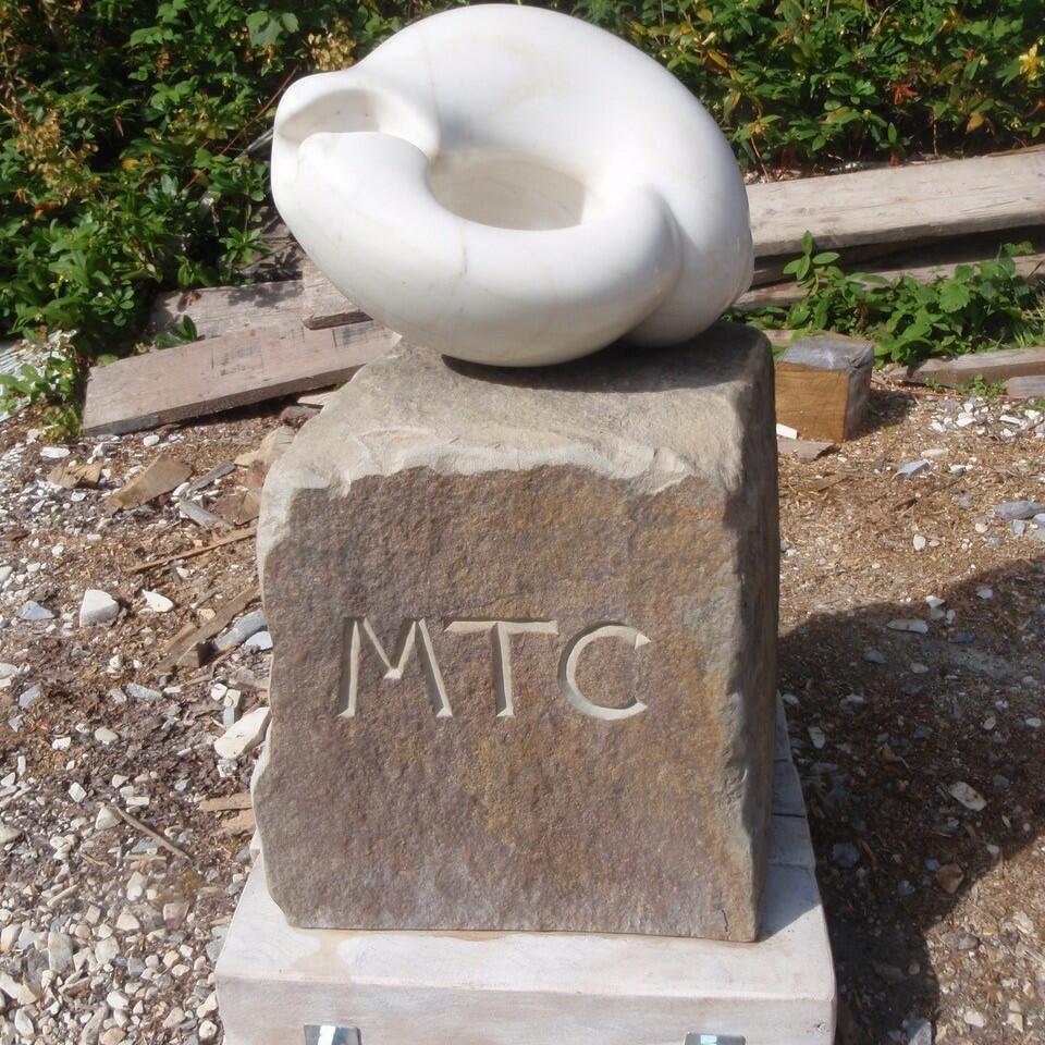 marble rounded sculpture on stone plinth