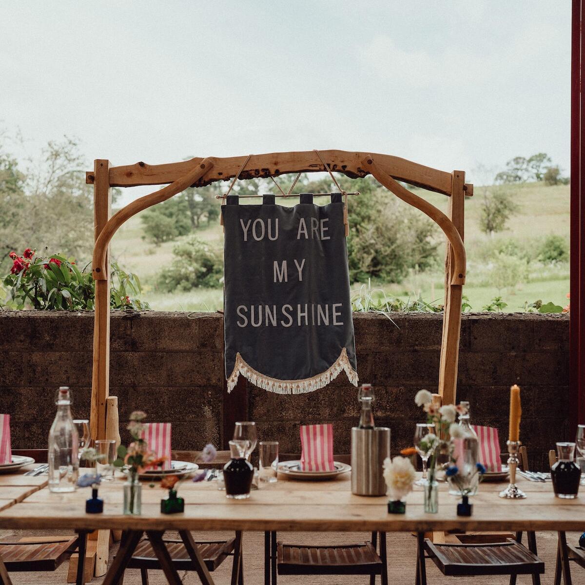 a rustic wedding sign behind the top table