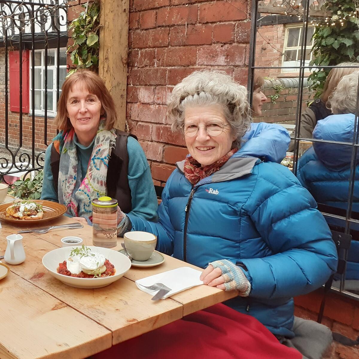 People eating breakfast on outdoor table