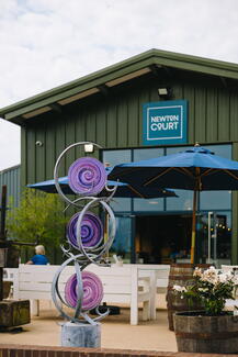 Colourful metal and glass sculpture outside Newton Court Restaurant