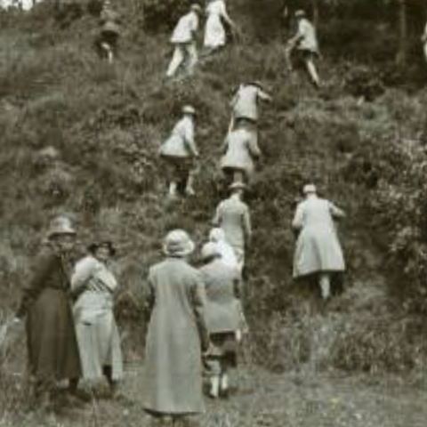 Old photograph showing members of the old straight club climbing a steep mound