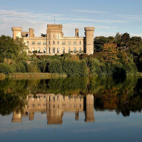 Eastnor castle overlooking a lake