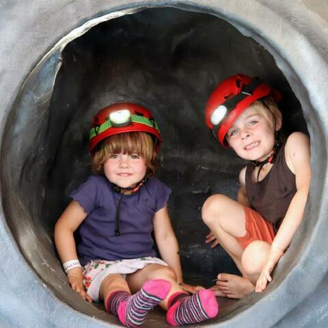 two children trying the mobile caving experience