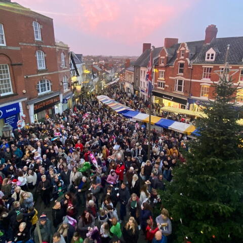 crowds gathered in a street for Christmas Faye