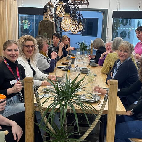 ladies sat around a large dining table for lunch