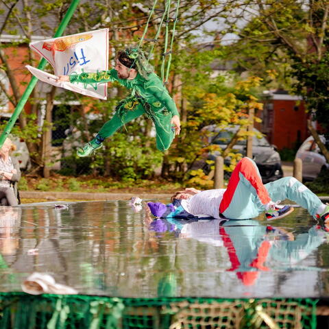 Acrobats performing a Fish Boy Show