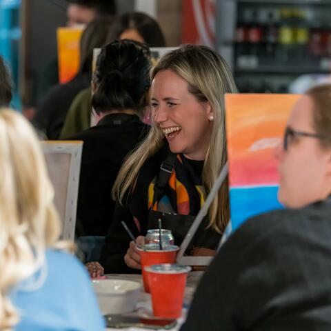 People laughing at a painting party