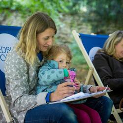 Lady on a festival deckchair with a baby