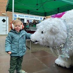 Child with polar bear sculpture