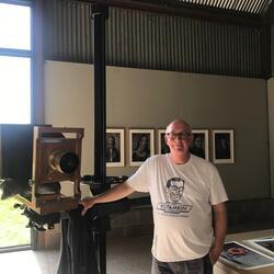 man stood with old fashioned camera