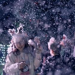 Children in winter wonderland with snow machine