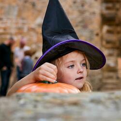 child with black pointy hat