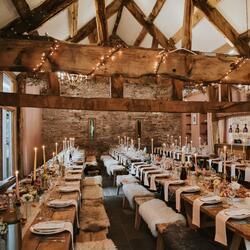 large dining room with wooden furnishings dressed for a country-style wedding