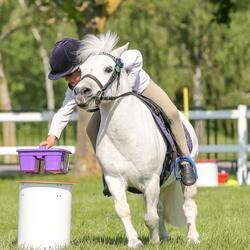 child on a white pony at event